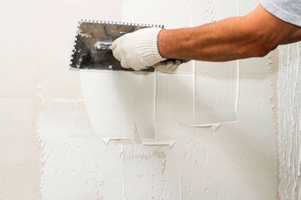 Drywall surface being skimmed before painting