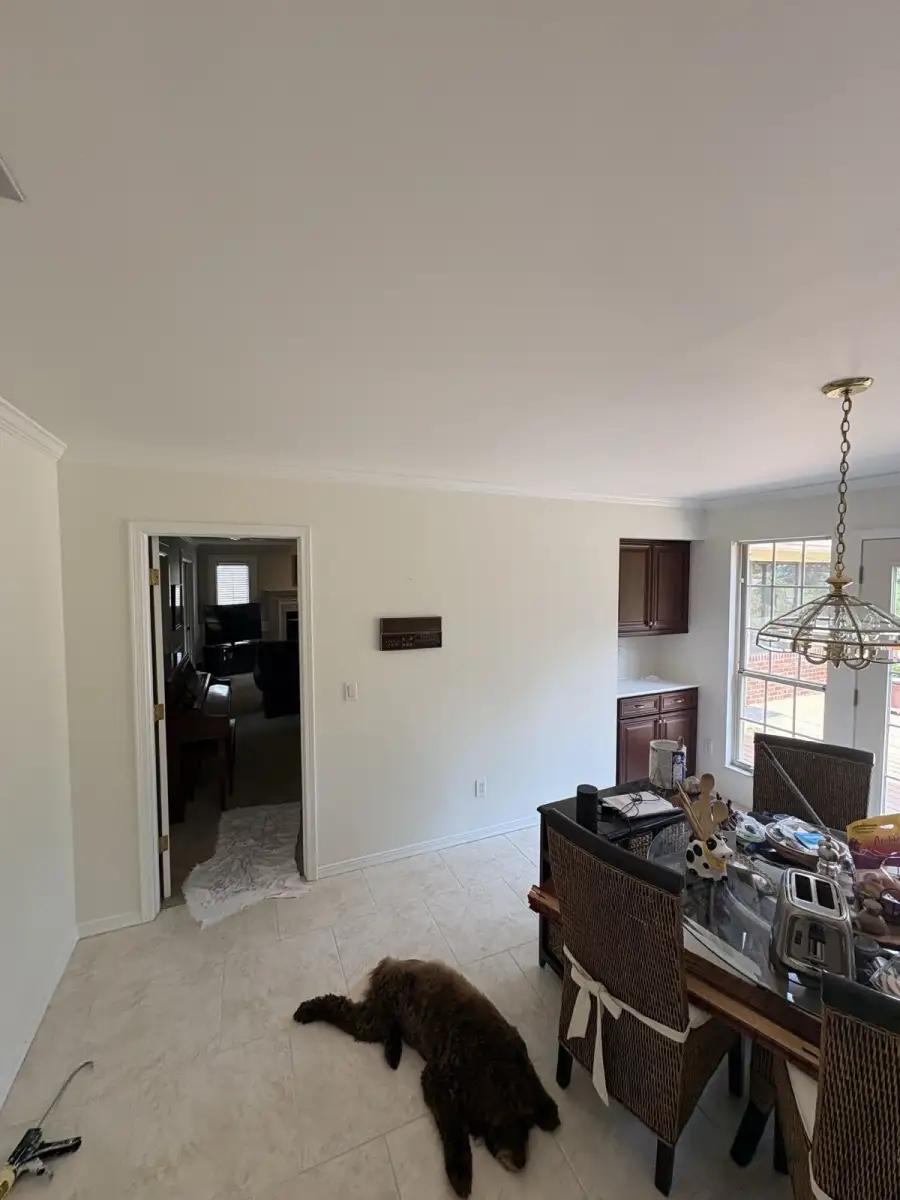 Completed dining room with light painted walls and crisp white trim viewed from the corner